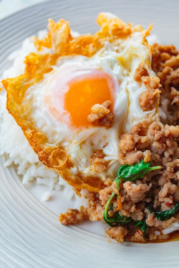 Rice Topped with Stirfried Pork and Basil Served with Fried Egg Stock