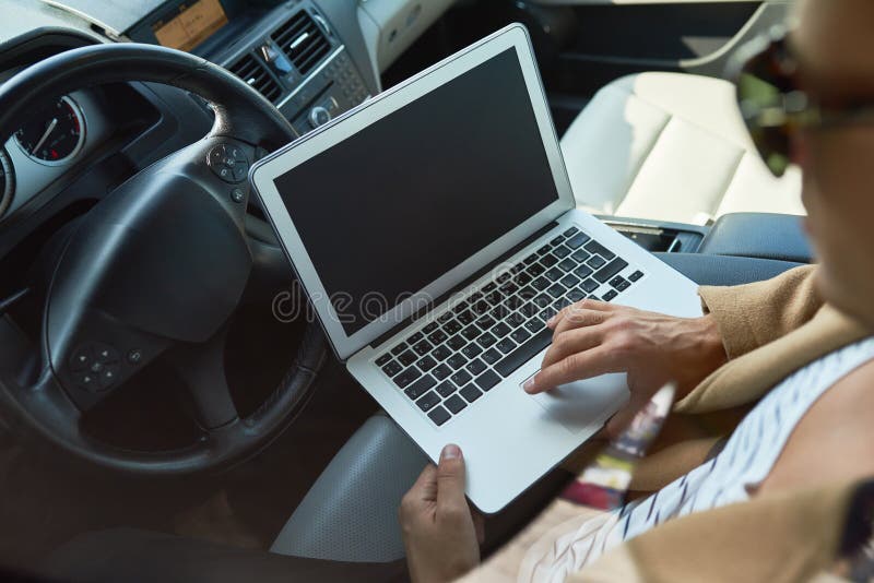 Rich Businessman using Laptop in Car royalty free stock image