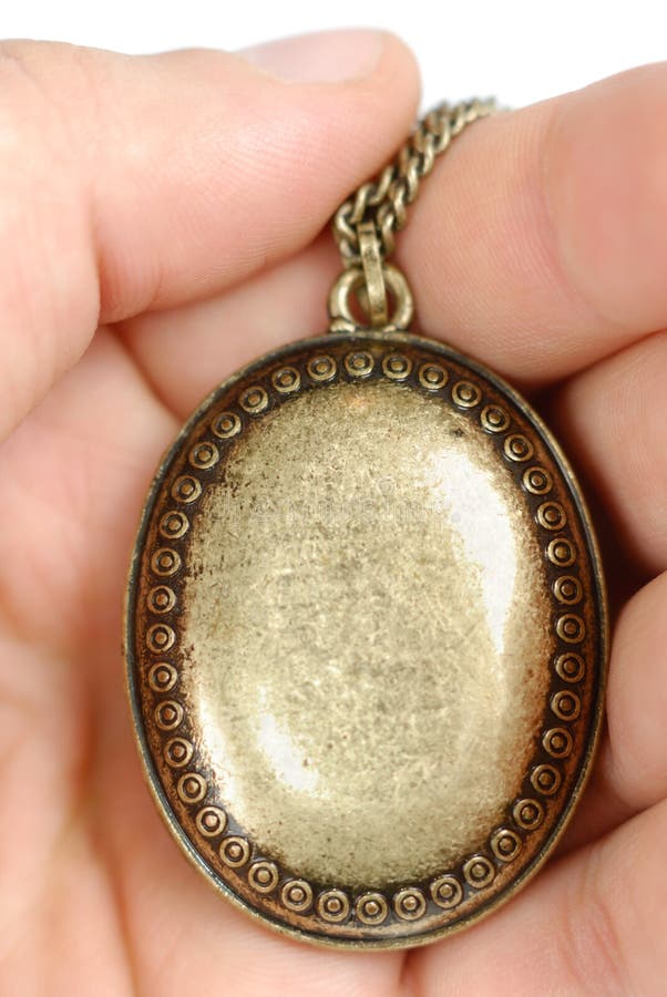 Male hand with old bronze locket isolated over white. Male hand with old bronze locket isolated over white