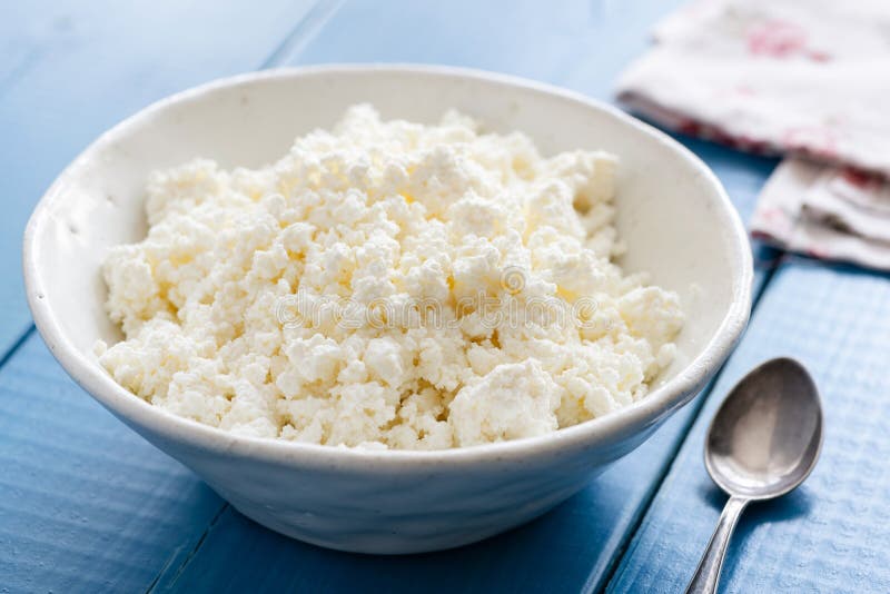Ricotta Or Cottage Cheese In White Bowl On Blue Table Stock Image