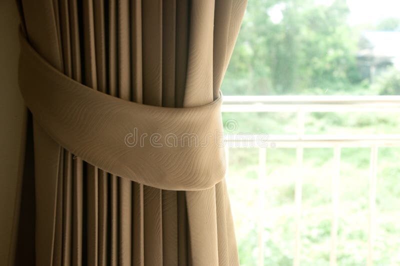 Brown curtain with the window lighting. Brown curtain with the window lighting