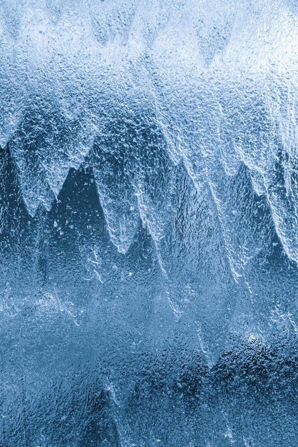 Water curtain falling down on clear glass with light reflection. Water curtain falling down on clear glass with light reflection