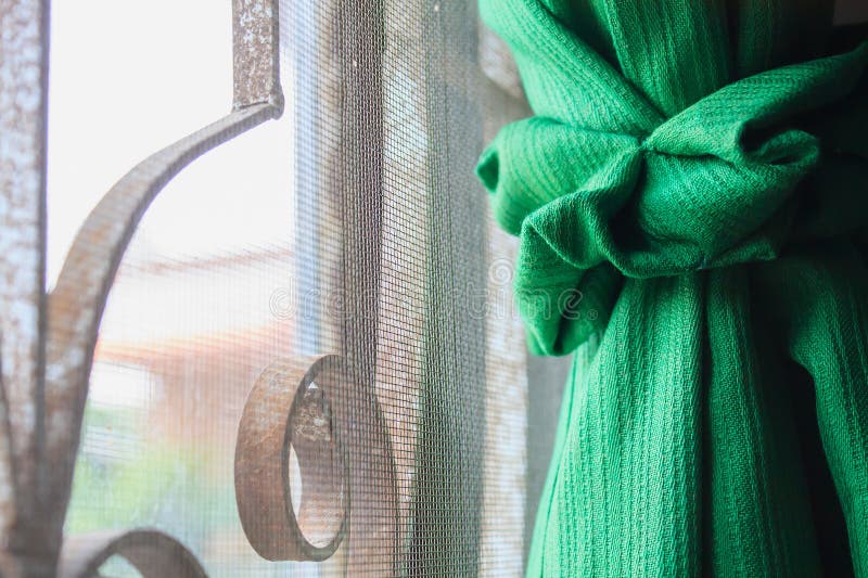 Green color window curtain close up. Green color window curtain close up