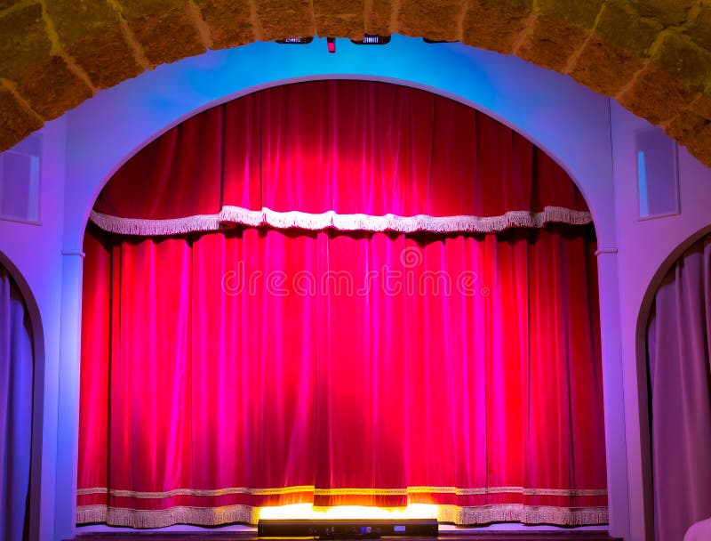 A red curtain in an old and very small Italian theatre. A red curtain in an old and very small Italian theatre.