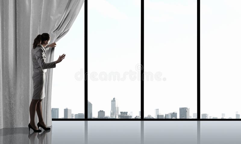 Businesswoman pulling curtain and cityscape behind it. Businesswoman pulling curtain and cityscape behind it