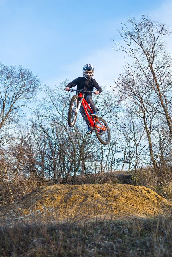 Rider is jumping on a mountain bike, an extreme sport.