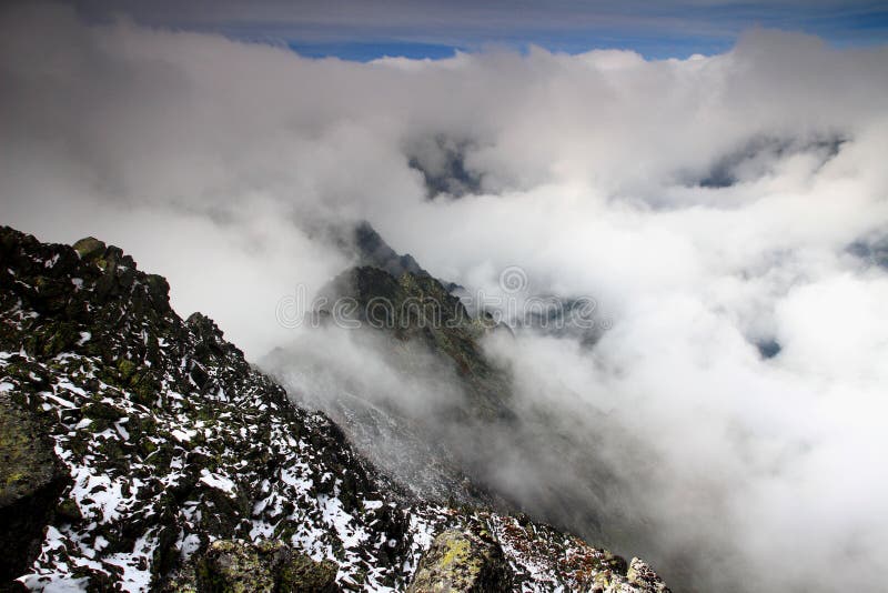 Ridge of Slavkovsky peak and Velka Studena valley in clouds