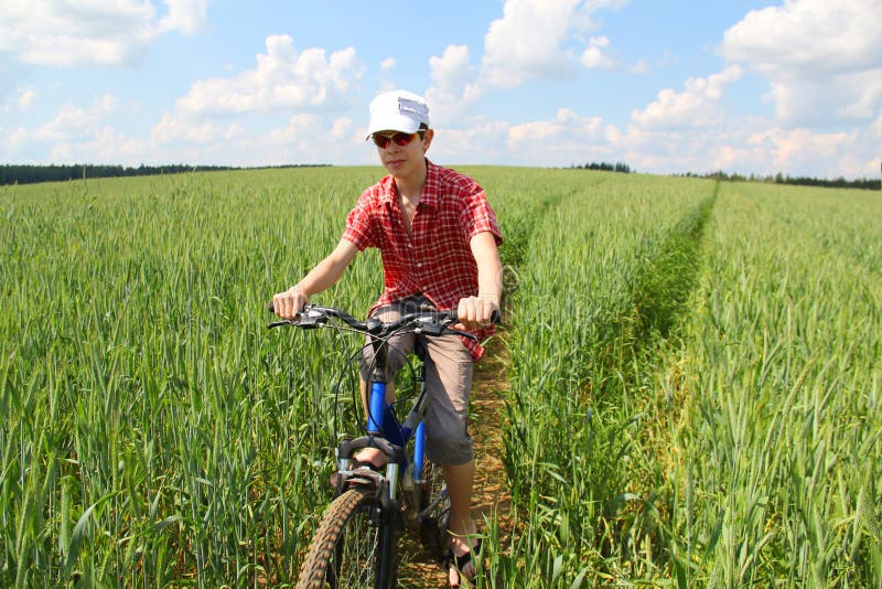 Riding a bicycle stock image. Image of lifestyle, cornfield - 25230659