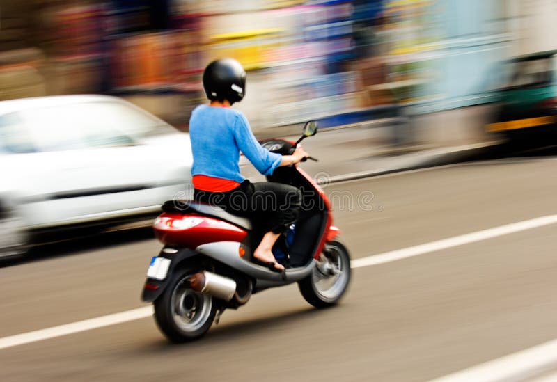 Riding a scooter stock photo. Image of motorcyclist, street 4284264