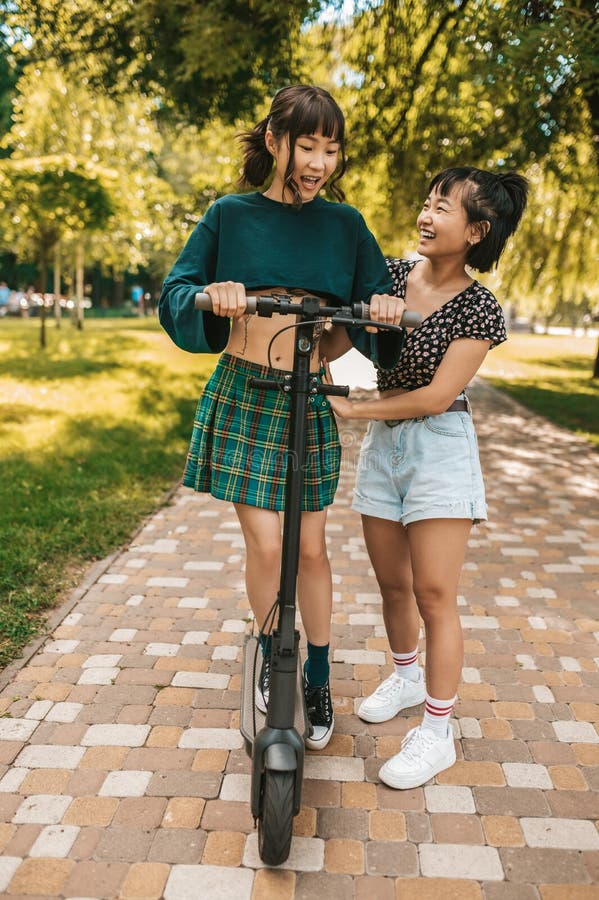 Cute Slim Young Girls Riding A Scooter In The Park Stock Image Image Of Scooter Ride 258703865