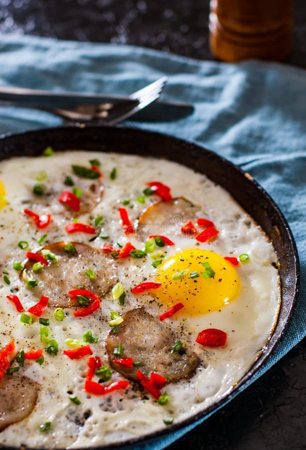 Ried Egg with Ham Sausage and Pepper in a Frying Pan Stock Photo