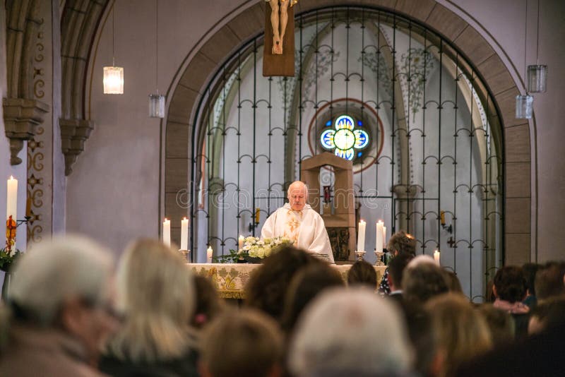 Rieden Germany 15.04.2018 Priest holding church service in front of crowd in theinterior of a church stock image Rieden Germany 15.04.2018 Priest holding church service in front of crowd in theinterior of a church stock image