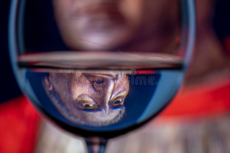 Inverted reflection in the goblet of water of the classic portrait of Cardinal Ludovico Trevisan created by Italian artist Andrea Mantegna in 1459. Inverted reflection in the goblet of water of the classic portrait of Cardinal Ludovico Trevisan created by Italian artist Andrea Mantegna in 1459