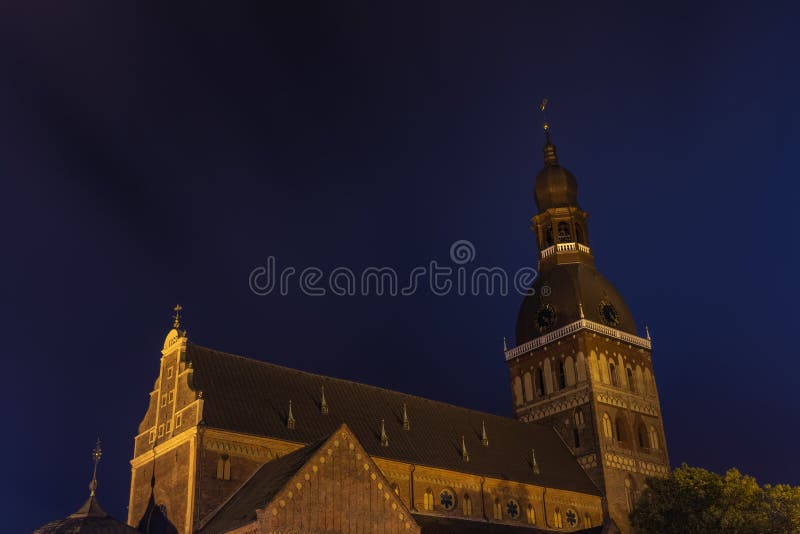 Riga Dome Cathedral at night- Medieval Lutheran church with elements of Romanesque architecture in Latvia stock photography Riga Dome Cathedral at night- Medieval Lutheran church with elements of Romanesque architecture in Latvia stock photography