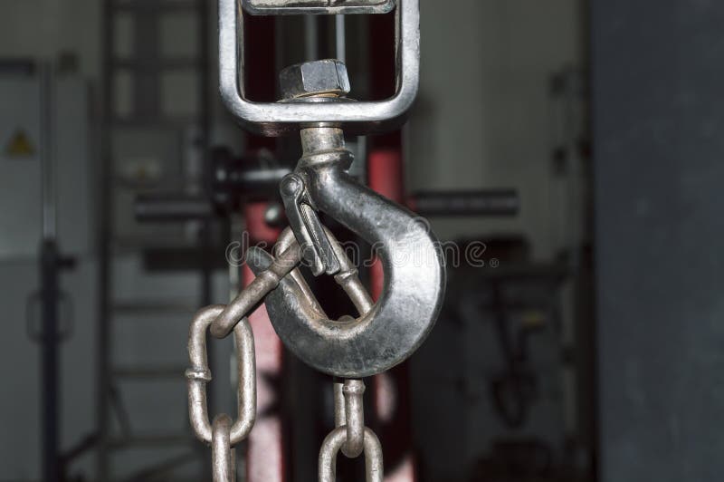 The Rigging Chain Hangs on the Hook of the Lifting Mechanism Stock