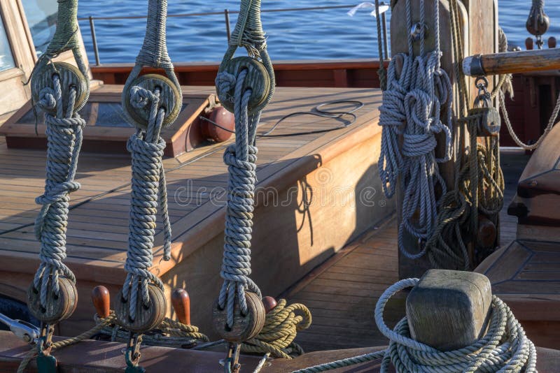 Rigging, ropes and knots on a historical old wooden sailing ship on a sunny day on the sea