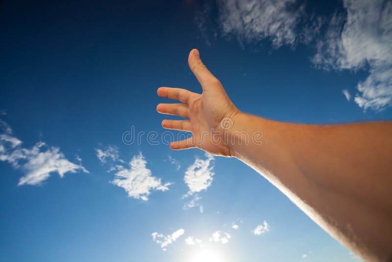 Right hand touching the blue sky with clouds stock photos