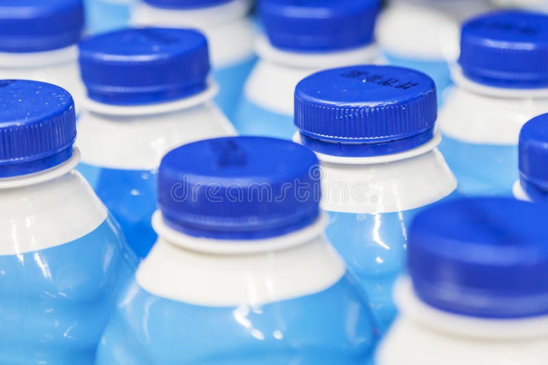 Rows with bottles of milk on the supermarket shelves. Rows with bottles of milk on the supermarket shelves