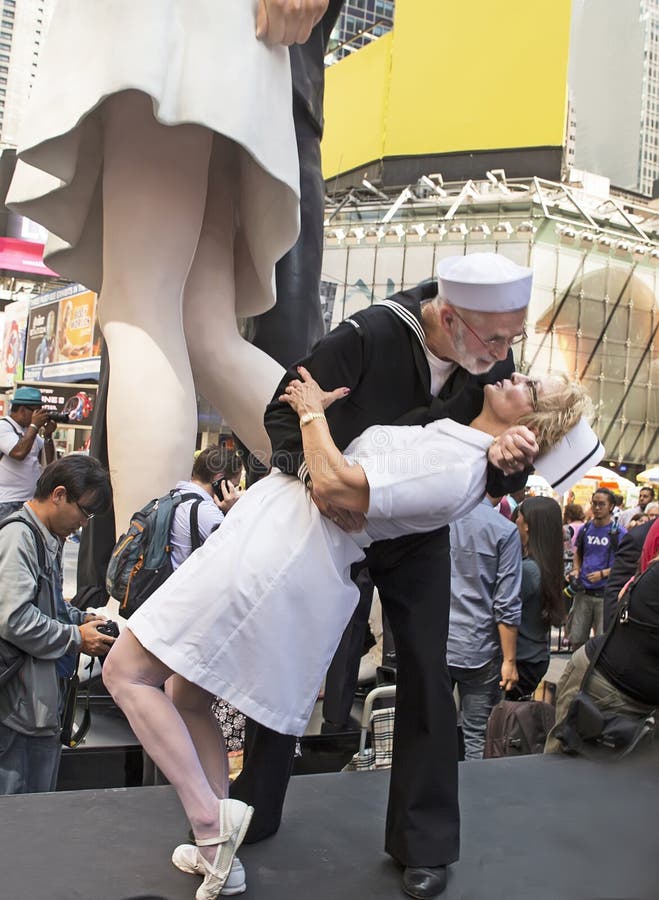 Steve and Pam Springer of Hagerstown, Maryland, reenact The Kiss. The event was the Times Square Kiss-In held on the Broadway Plaza between 43rd and 44th Streets on August 14, 2015. This marks the 70th Anniversary of Victory Over Japan Day (V-J Day) marking Japan's surrender in World War Two. For a few days, a 25-foot sculpture in back of the pair) entitled, Embracing Peace, by Seward Johnson, was placed some meters away from where the iconic photo of a celebrating sailor in a white hat planting a kiss on a young woman in a white skirt (possibly a nurse's attire) was snapped by the noted photographer, Alfred Eisenstaedt, 70 years earlier. The Times Square Alliance organized the project as part of a series of events honoring World War II veterans. Steve and Pam Springer of Hagerstown, Maryland, reenact The Kiss. The event was the Times Square Kiss-In held on the Broadway Plaza between 43rd and 44th Streets on August 14, 2015. This marks the 70th Anniversary of Victory Over Japan Day (V-J Day) marking Japan's surrender in World War Two. For a few days, a 25-foot sculpture in back of the pair) entitled, Embracing Peace, by Seward Johnson, was placed some meters away from where the iconic photo of a celebrating sailor in a white hat planting a kiss on a young woman in a white skirt (possibly a nurse's attire) was snapped by the noted photographer, Alfred Eisenstaedt, 70 years earlier. The Times Square Alliance organized the project as part of a series of events honoring World War II veterans.