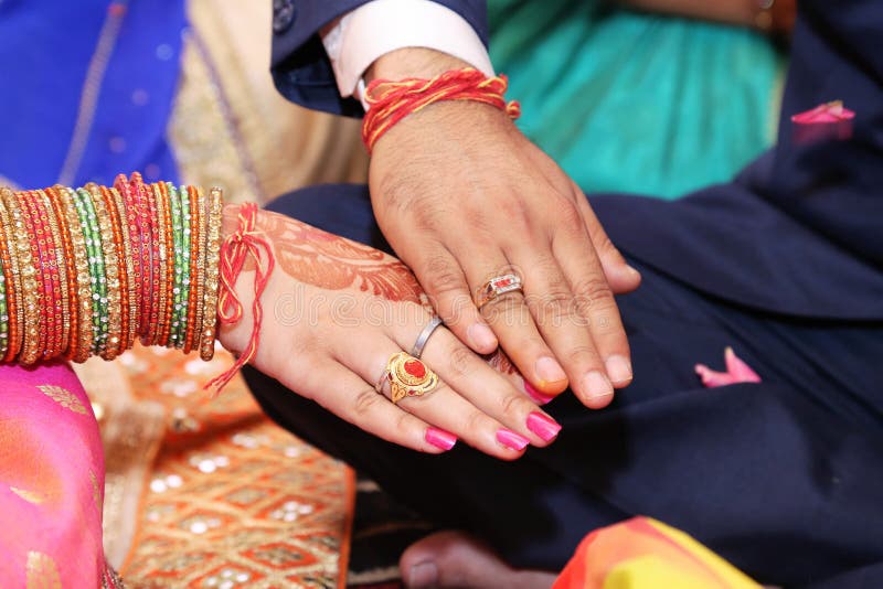 Bride Putting Engagement Ring in Groom`s Finger. Stock Photo - Image of  flower, african: 184095176