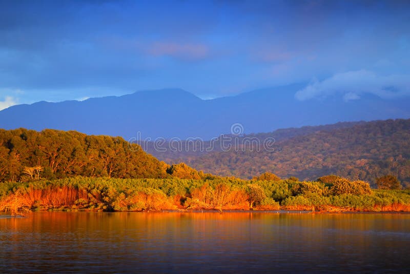 Rio Tarcoles, Carara National Park, Costa Rica. Sunset in beautiful tropical forest landscape. Meanders of river Tarcoles. Hills w