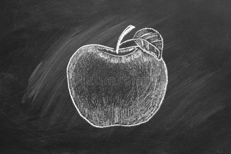 Ripe apple on blackboard