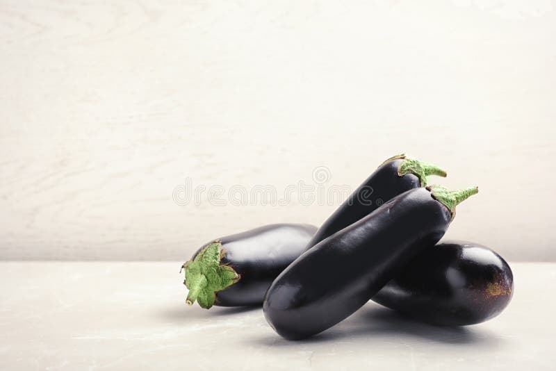 Ripe eggplants on table stock photo. Image of light 125192308
