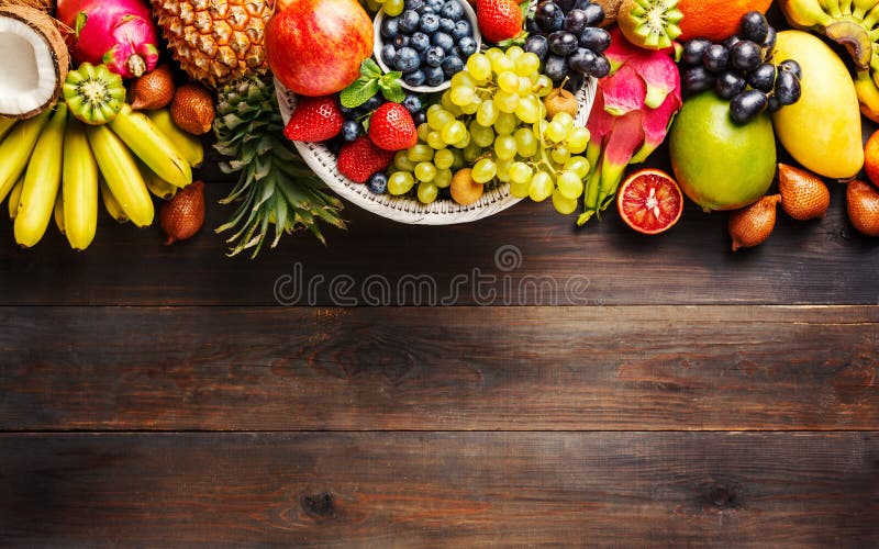 Ripe fruit and berries on a wooden background