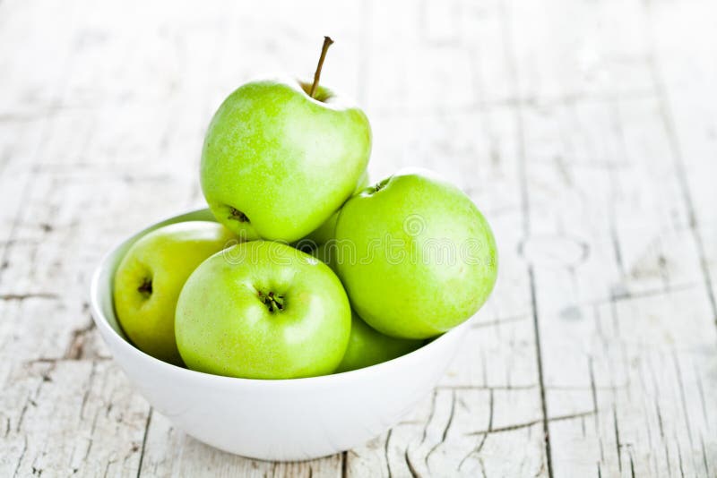 Ripe green apples in bowl