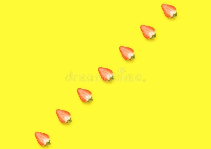Ripe juicy strawberries cut in half arranged in diagonal on bright yellow background. Creative minimalist flat lay. Vitamins vegan royalty free illustration Ripe juicy strawberries cut in half arranged in diagonal on bright yellow background. Creative minimalist flat lay. Vitamins vegan royalty free illustration