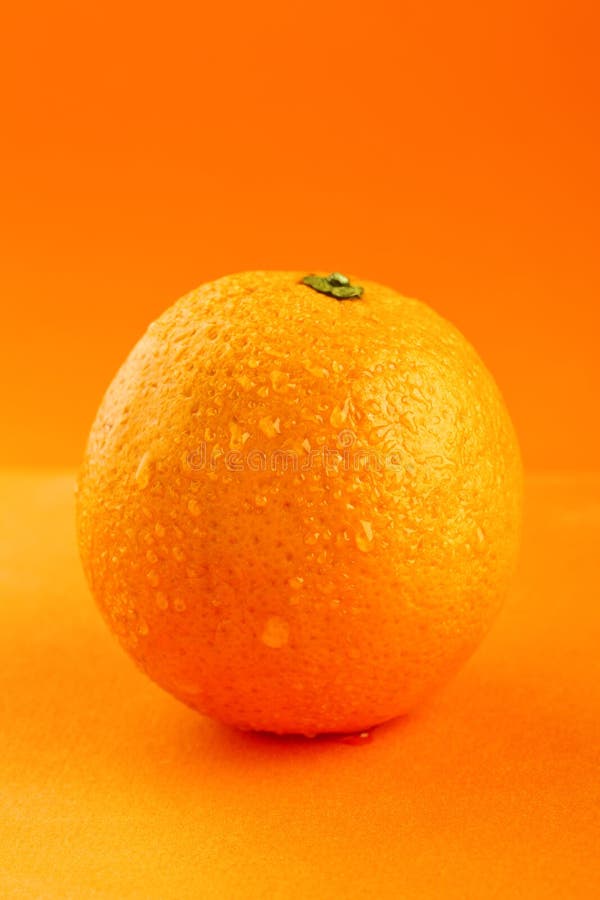 Ripe orange with drops of water