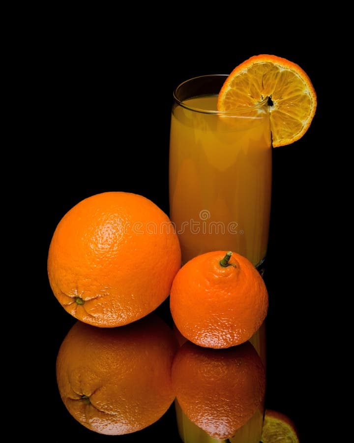 Mandarin, Orange and Glass of Juice on a Black Background Stock Photo