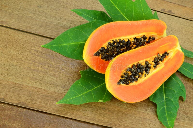 Ripe papaya on wood background.