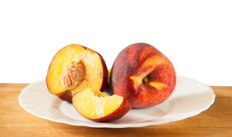 Ripe peaches on the wooden background, selective focus