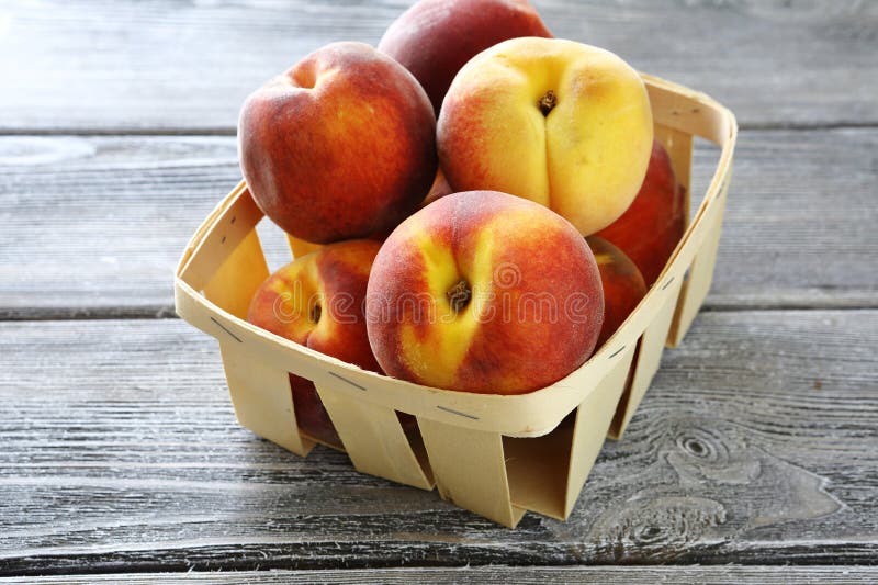 Ripe peaches in wooden box