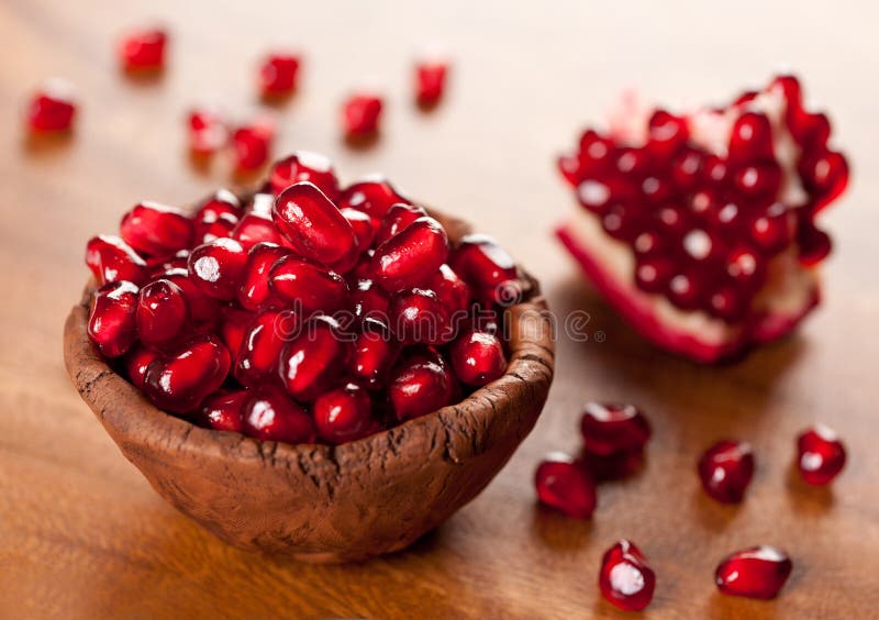 Ripe pomegranate grains in a ceramic bowl