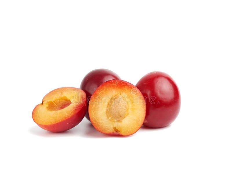 Ripe red whole and halves of plum isolated on white background