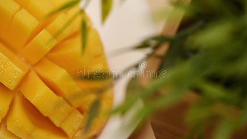 Ripe sliced juicy delicious Asian mango dice squared cubes cut moving in 4k slow motion