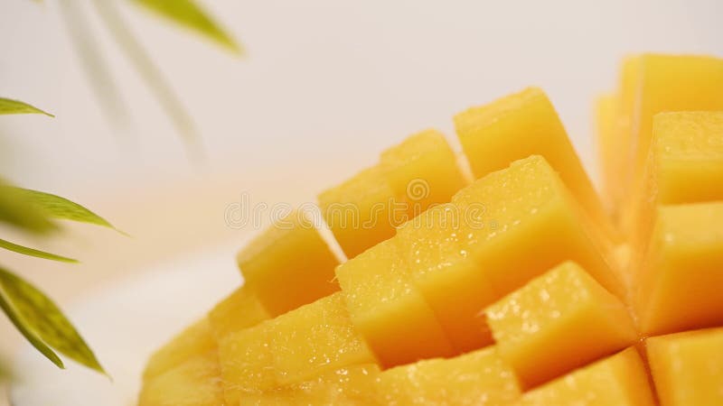 Ripe sliced juicy delicious Asian mango dice squared cubes cut moving in 4k slow motion