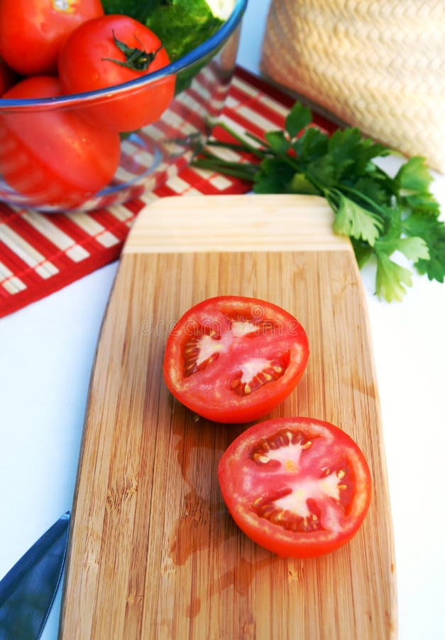 Ripe sliced tomatoes on a wooden board