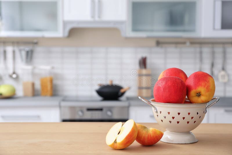 Ripe Apples and Blurred View of Kitchen Interior on Background Stock