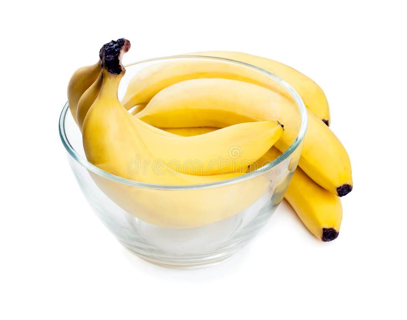 Ripe yellow bananas lie in a clear glass deep plate