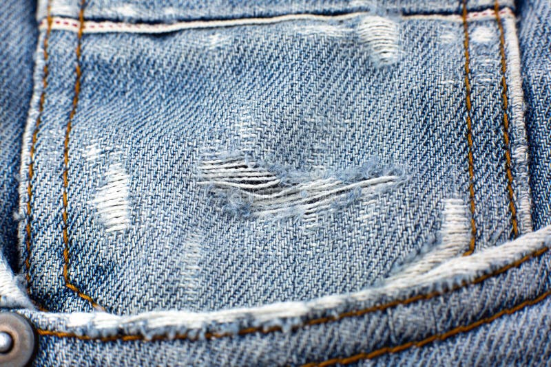 Ripped Blue Hipster Jeans Material. Destroyed Denim Cloth Texture Stock