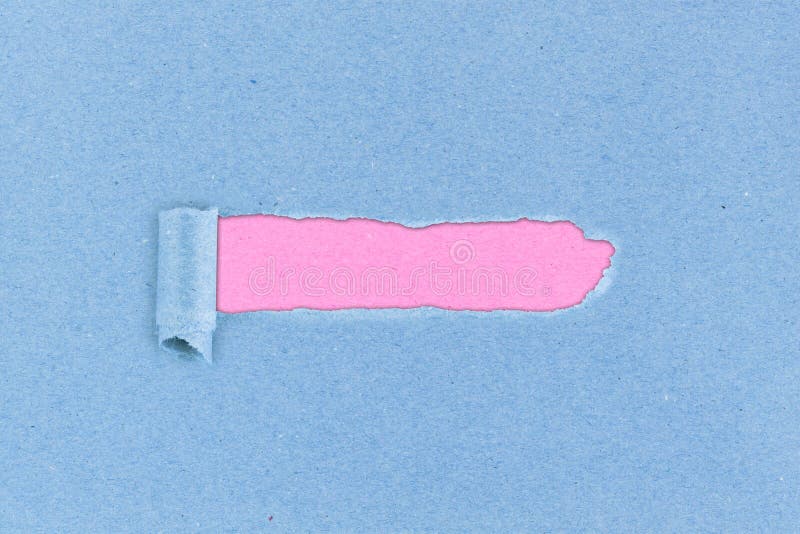 Ripped hole in blue paper pink background