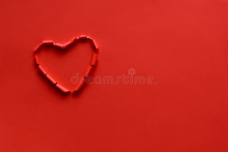 Ripped paper hole heart shaped on red paper background. Valentine`s day celebration concept stock photos Ripped paper hole heart shaped on red paper background. Valentine`s day celebration concept stock photos