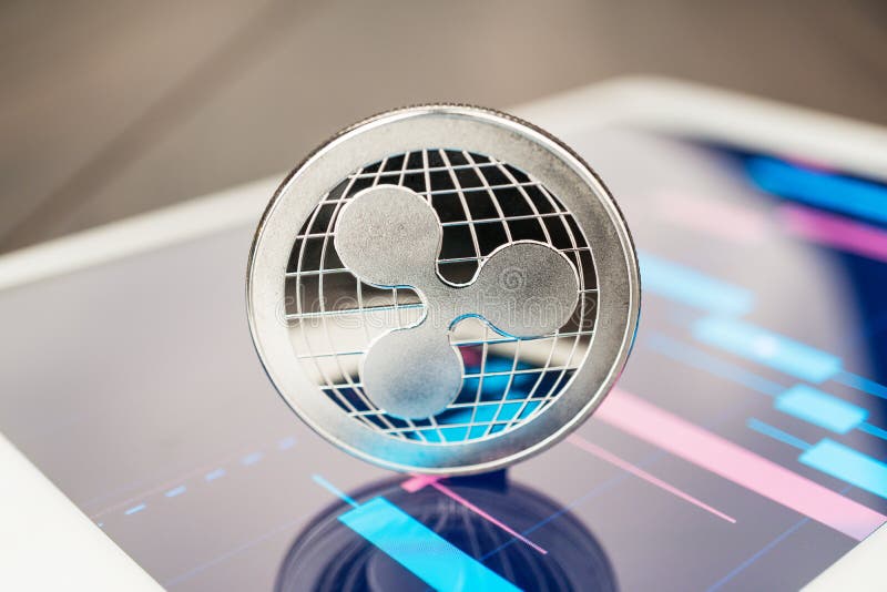 Close-up photo of ripple cryptocurrency physical coin on the tablet computer showing stock market charts. trading ripple crypto stock photography Close-up photo of ripple cryptocurrency physical coin on the tablet computer showing stock market charts. trading ripple crypto stock photography