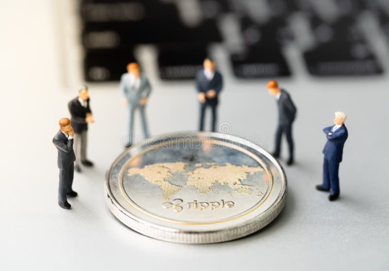 Ripple XRP Coin And Businessmans On Notebook. Stock Photo ...