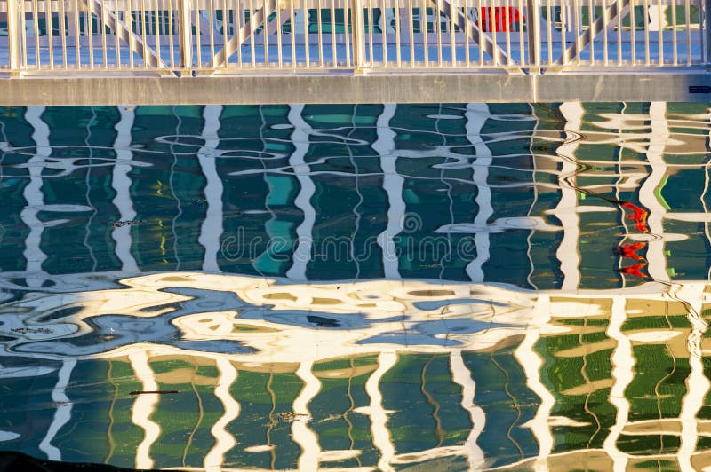 Rippling water surface in Boston harbor produces distortions in reflections of surrounding buildings. Rippling water surface in Boston harbor produces distortions in reflections of surrounding buildings