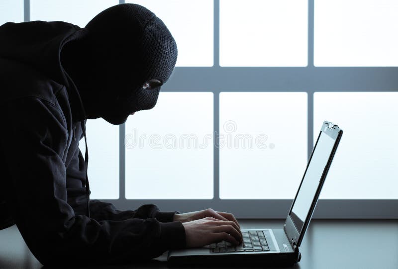 Computer hacker - Male thief stealing data from laptop. Computer hacker - Male thief stealing data from laptop