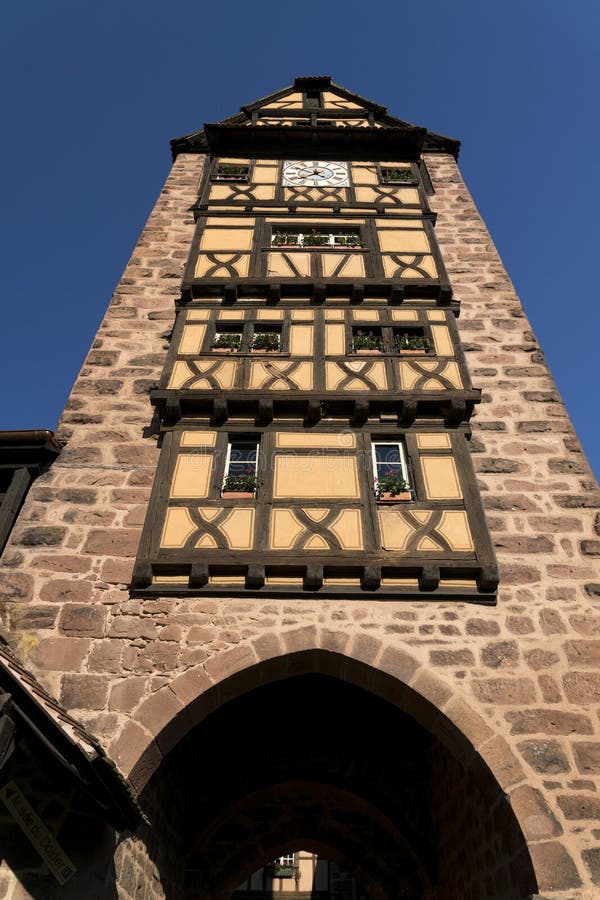 RIQUEWIHR FRANCJA MAJA 30 R. 2019 : Wieczór z wieżową wieżą i tradycyjnymi kolorowymi domami w Riquewihr zdjęcia royalty free